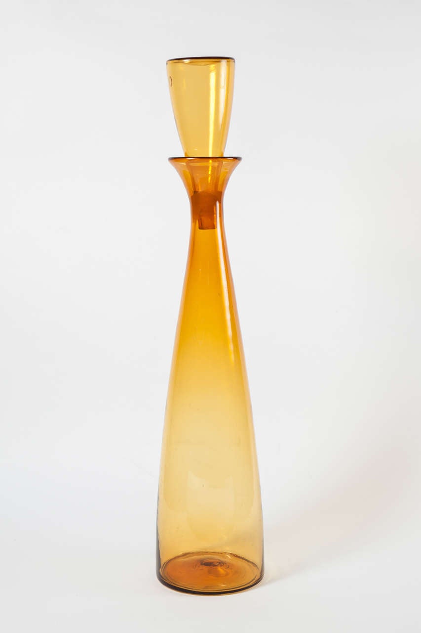 Monumental decanter floor vase by Blenko. USA, circa 1950.  Amber glass; removable stopper. Height without stopper, 30 inches.