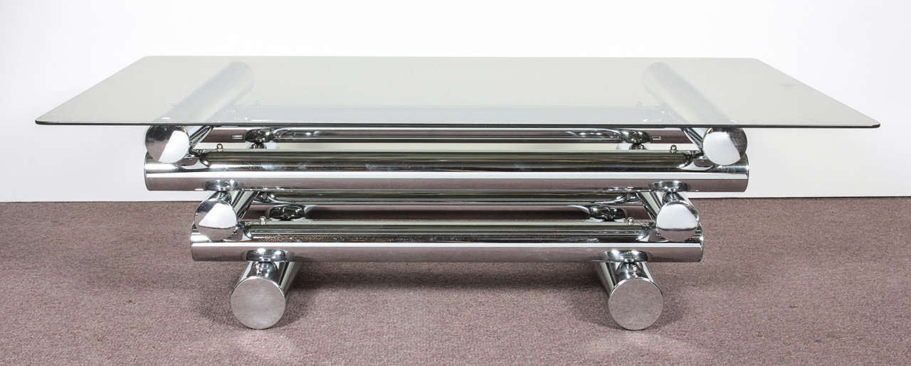 Constructivist style cocktail table in chrome with a smoke glass top. Three tiers of tubular metal logs secured one on top of the other in rectangular formation.
The actual base measures 31 1/2" wide x 21 1/2" deep.
 if you need the glass