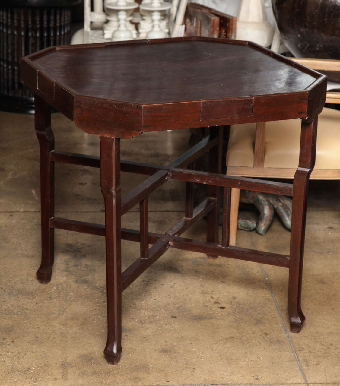 An octagonal card table from Cambodia, with four drawers.