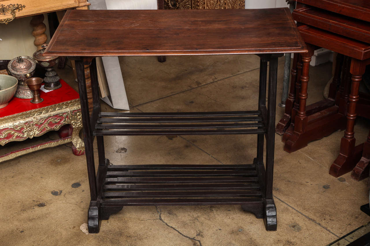 A side table with two shelves and in two toned wood, from Thailand.