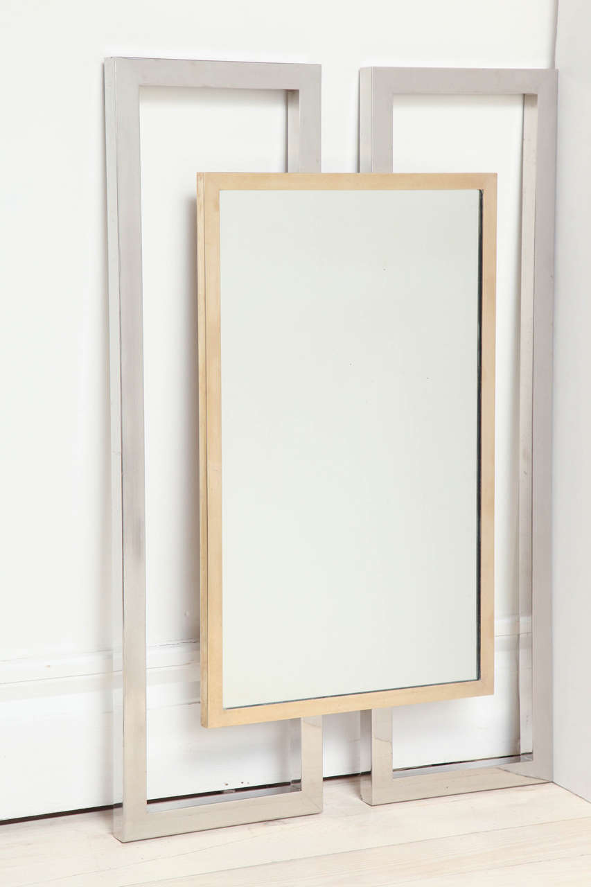Large brass mirror with shaped, extended chrome outer frame.