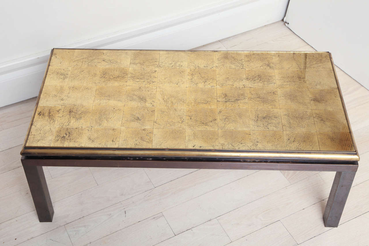 Metal coffee table with reverse gilded glass top, by Guy Lefevre for Maison Jansen.