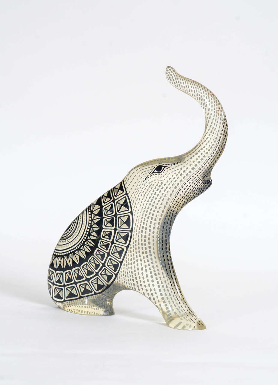 Cute sitting elephant blowing his trunk. A design by Abraham Palatnik. 

The Brazilian artist Abraham Palatnik (1928) was the founder of the technological movement in Brazilian art, and a pioneer in making kinetic sculptures. 
In the late 40th