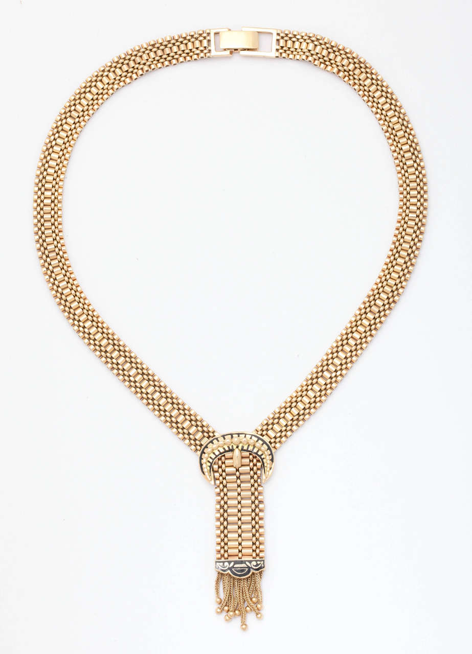 A fabulous 14-karat woven  gold chain in a Egyptian revival design with ending  tassel.