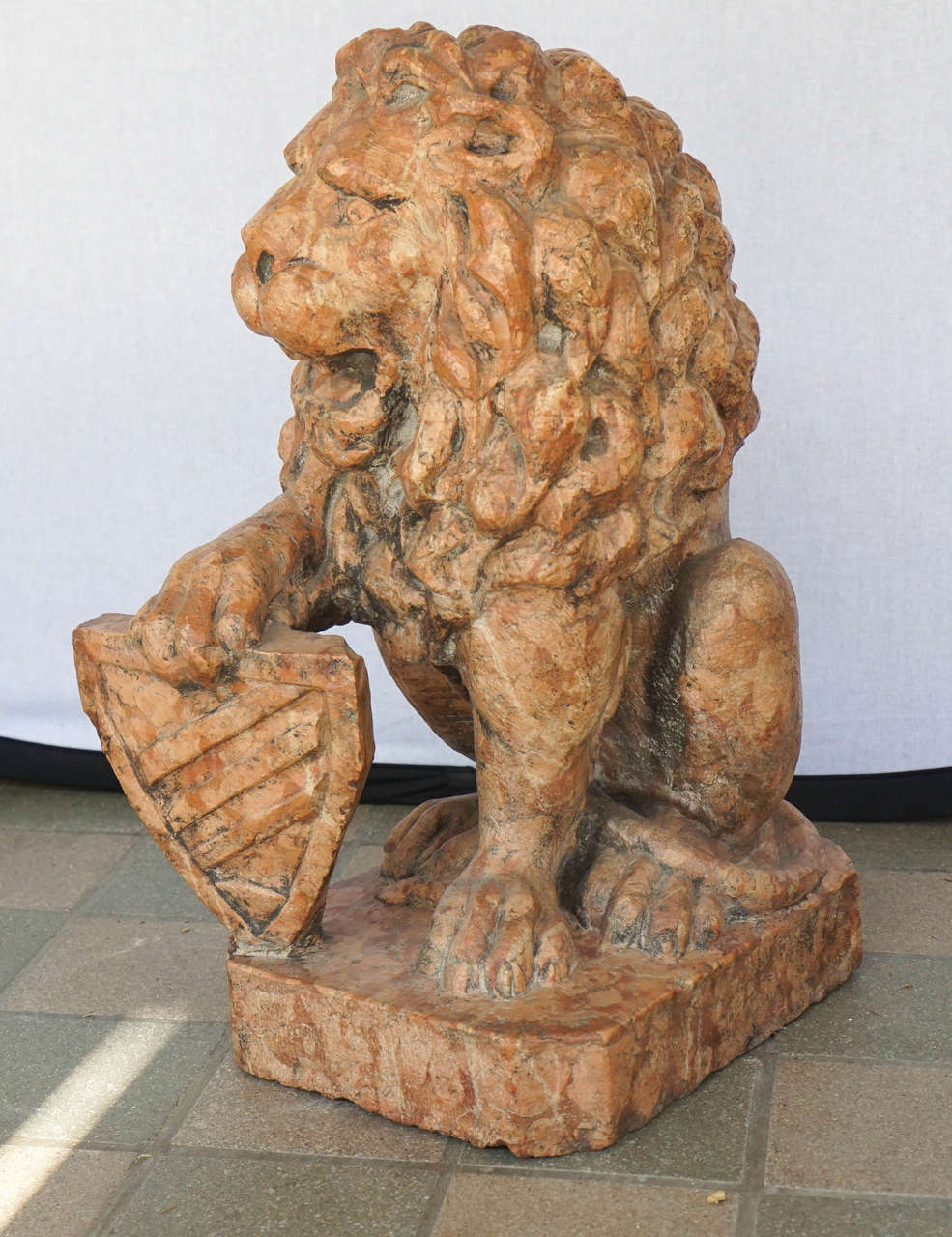 This fine and masculine sculpture of a rampant lion with shield was made in France around  1850 to 1860. Sculpted in a Baroque revival style likely as a heraldic device to denote property and family association the marble selection and power in the
