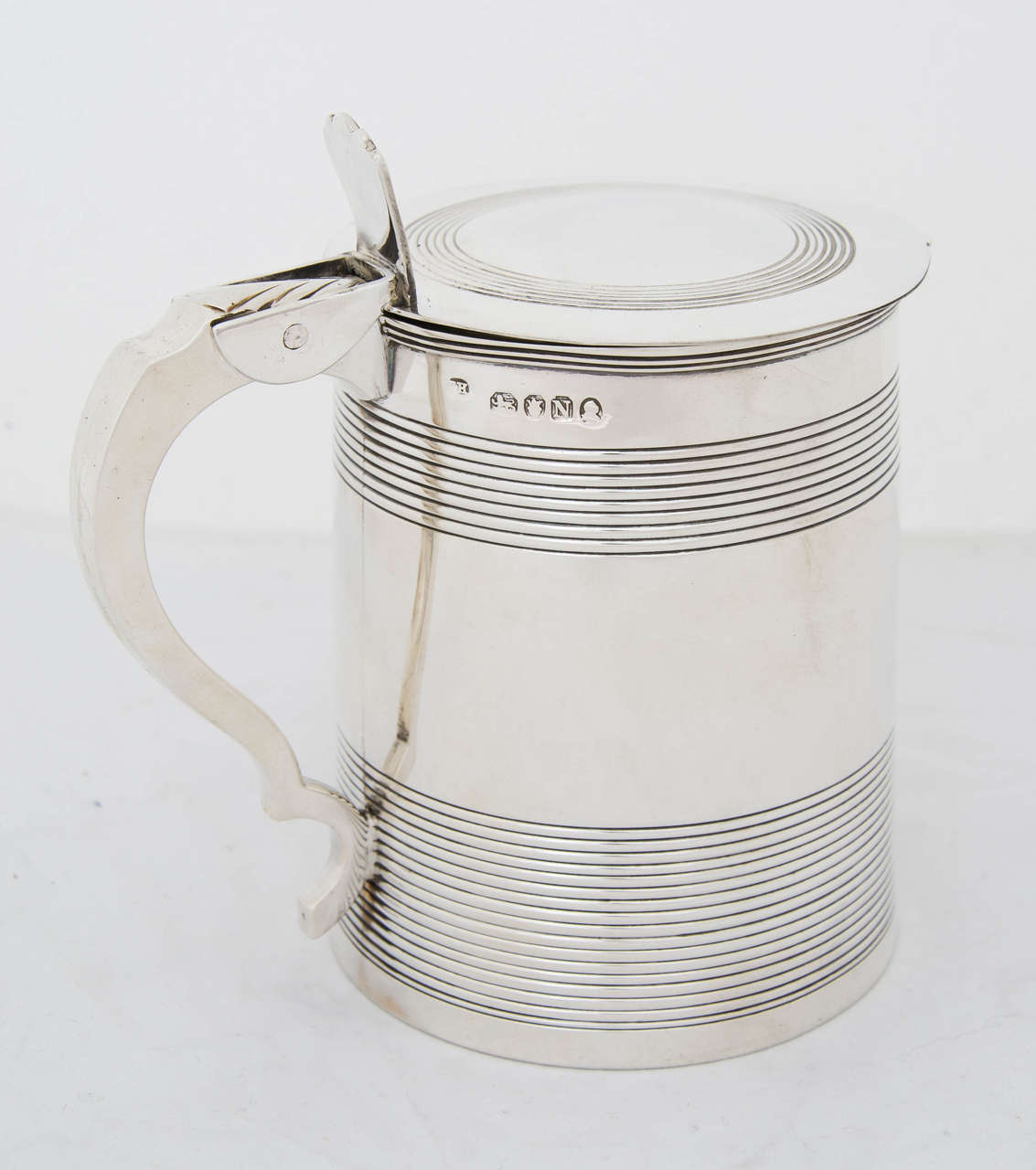 A George II English sterling silver tankard made in London 1808 by Thomas Hayter.
Height to top of thumb-piece is 5.5