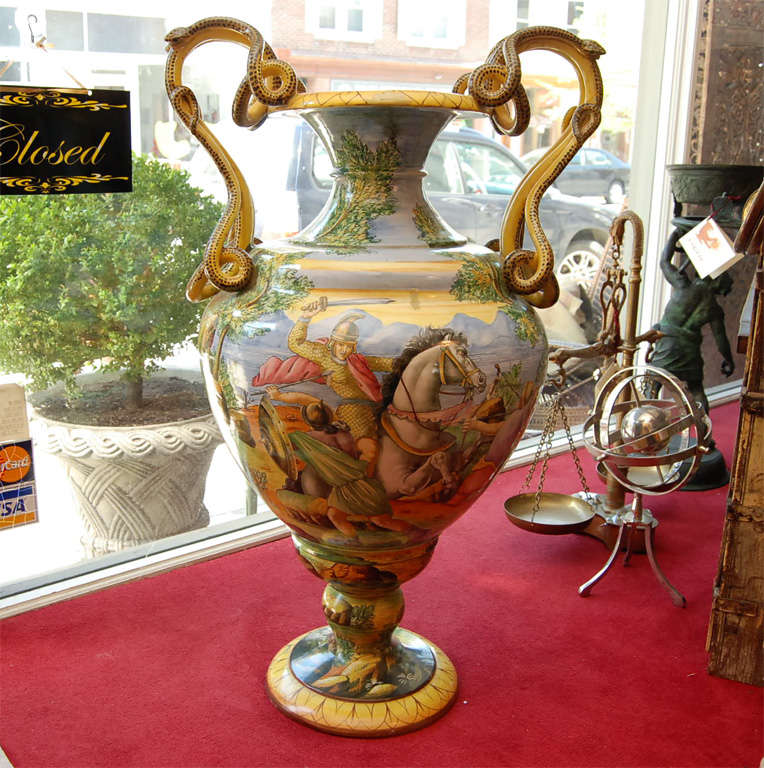A Italian grand tour majolica urn with heroic scenes and serpent handles.
