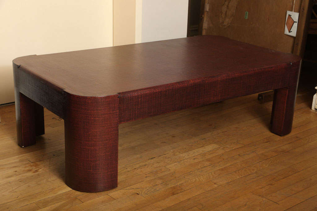 A rectangular lacquered linen coffee table with rounded corners. Each rounded corner extending into leg, the rounded edges above apron of table in the manner of American designer Karl Springer.
