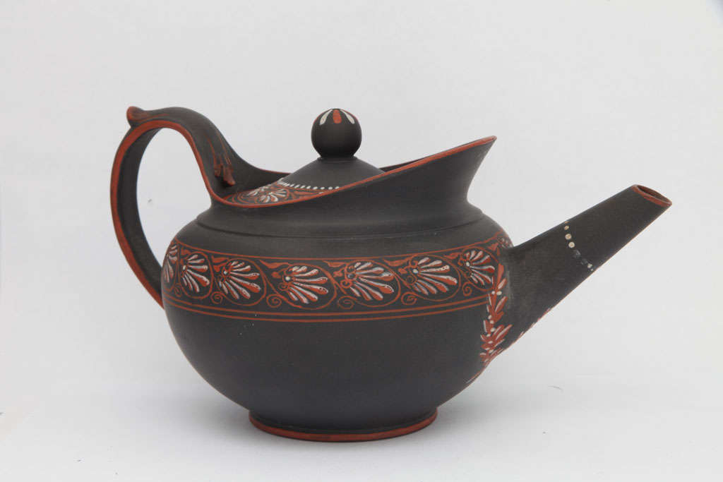 A rare signed Wedgwood basalt teapot with orange and white encaustic decoration, upper case mark
