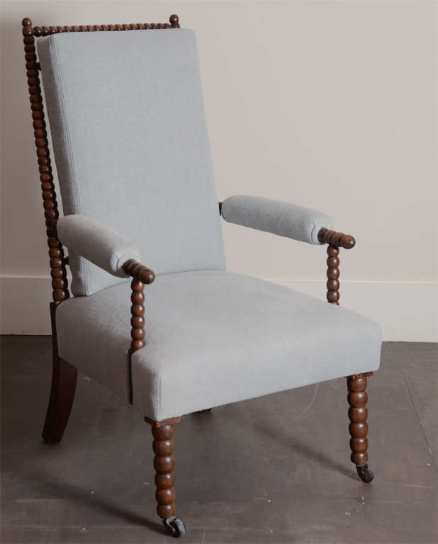 English Bobbin Chair with front casters. Newly upholstered in pale blue linen.