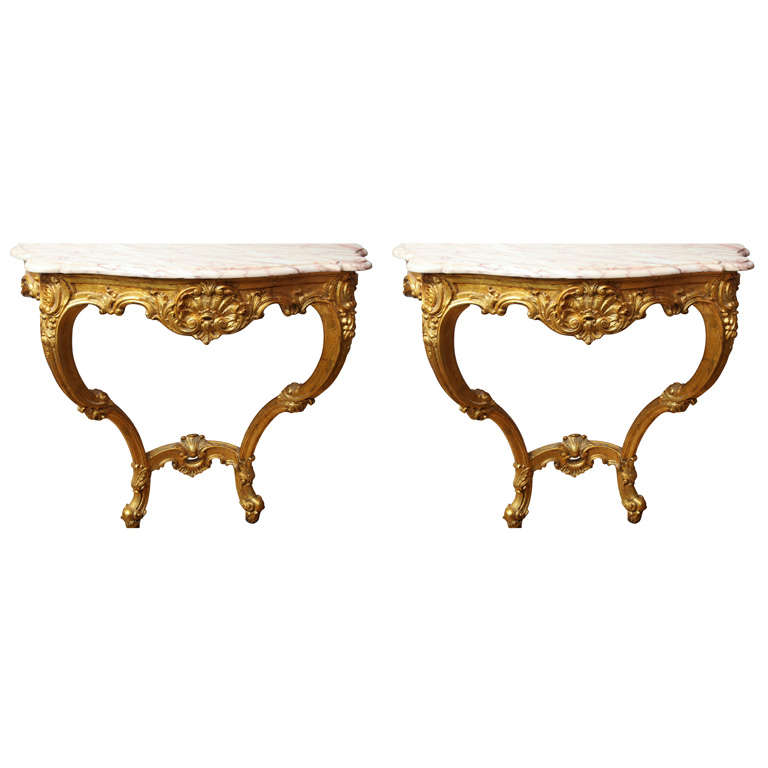 A pair of French Louis XV style wall mounted console tables
