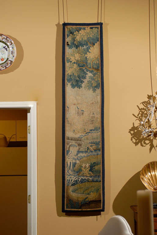 Originally part of a much larger tapestry, this panel adds the same texture and warmth to a home as the larger piece it came from.  It is unusual to find so many of the elements used in Aubussons on such a small piece.  We have foliage at the top,