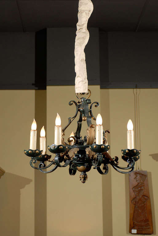 Old French iron chandelier with eight arms, circa 1940
This wonderful old French chandelier is made of hearty iron. It has eight arms so will supply a good amount of light. This chandelier also has some nice details including a dark green and gold