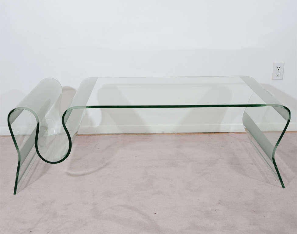 A vintage coffee or cocktail table with an organic, curving form. The sunken curve at one end is ideal for magazines or coffee-table books. The piece has frosted glass accents on the corners and sides.

Reduced from: $5,800