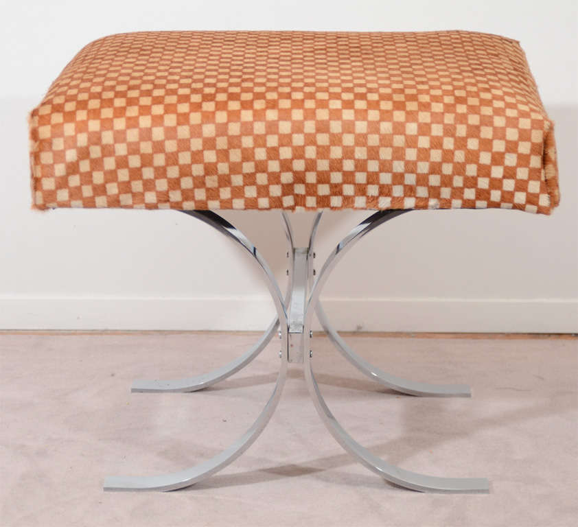 A pair of vintage stools with a chrome, curved, x-form base and brown and tan checkered upholstery. They are by noted designer Milo Baughman
