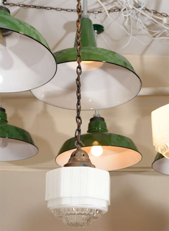 A set of six English hanging fixtures. The shades are milk glass with a clear glass bottom.
