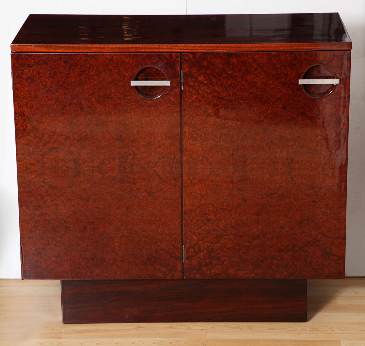 Gilbert Rohde Art Deco small sideboard by Herman Miller in rosewood, burl, and mahogany with satin nickel hardware.