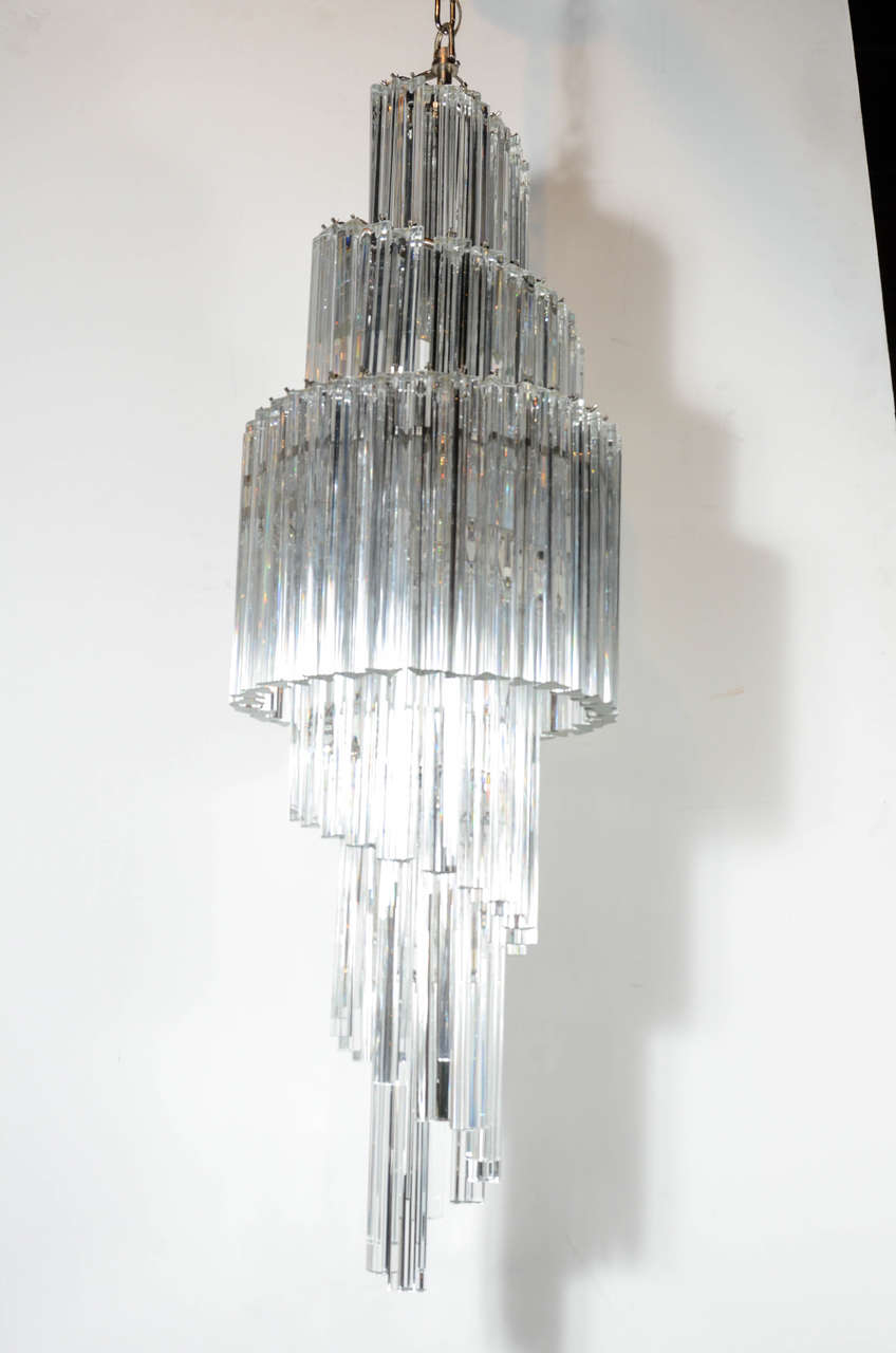 This glamorous large Mid-Century spiral chandelier features a series of clear Murano triedre crystals suspended from a chrome frame that accommodates eight chandelier bulbs. This piece is perfect for foyers, stairwells & dining rooms and will make a