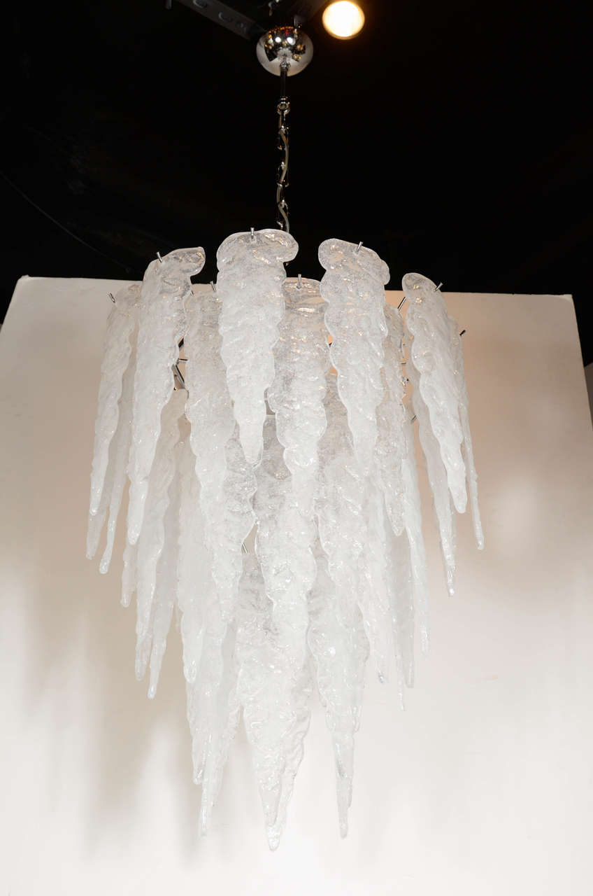 This sculptural Mid-Century chandelier features a sculptural stylized icicle design by Salviati. Made from frosted hand blown Murano glass suspended on a chrome frame. This unique style will demand attention where ever it is.
It has been newly