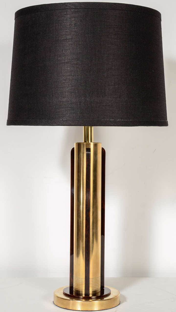 Pair of Art Deco Machine Age table lamps by Chase in Copper  with four fluted skyscraper style bakelite accents.  Includes new custom shades and has been newly re-wired.