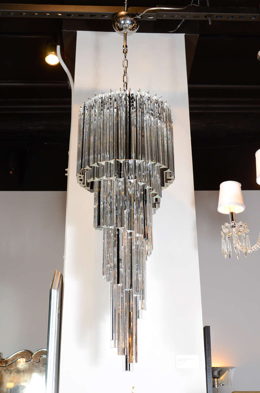 This spectacular Italian chandelier features clear Murano glass rods with feature black glass rods that cascade from the upper layer into a spiral design. This piece has been newly rewired to American standards and the overall hanging height can be