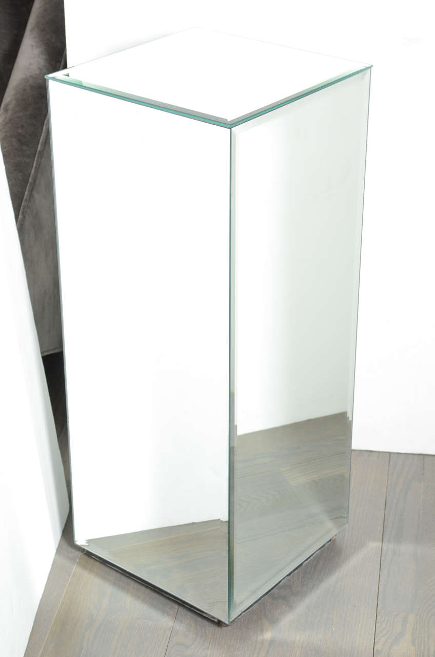 This pedestal is mirrored on all four sides and also the top. Each panel is hand beveled. It's perfect for displaying sculptures or objects.