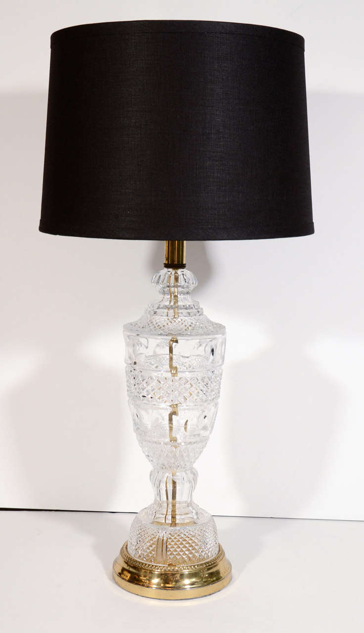 Pair of elegant mid-century modern cut crystal lamps. The lamps have baluster forms, and feature convex circle accents and cross hatch designs, creating a diamond pattern. Newly rewired with antique brass base and fittings. Shown with custom drum