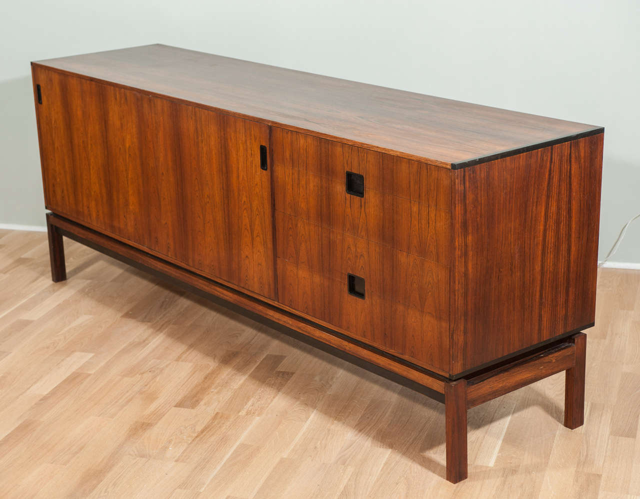 A beautifully designed and made credenza with rich rosewood grain and ebony coloured details.