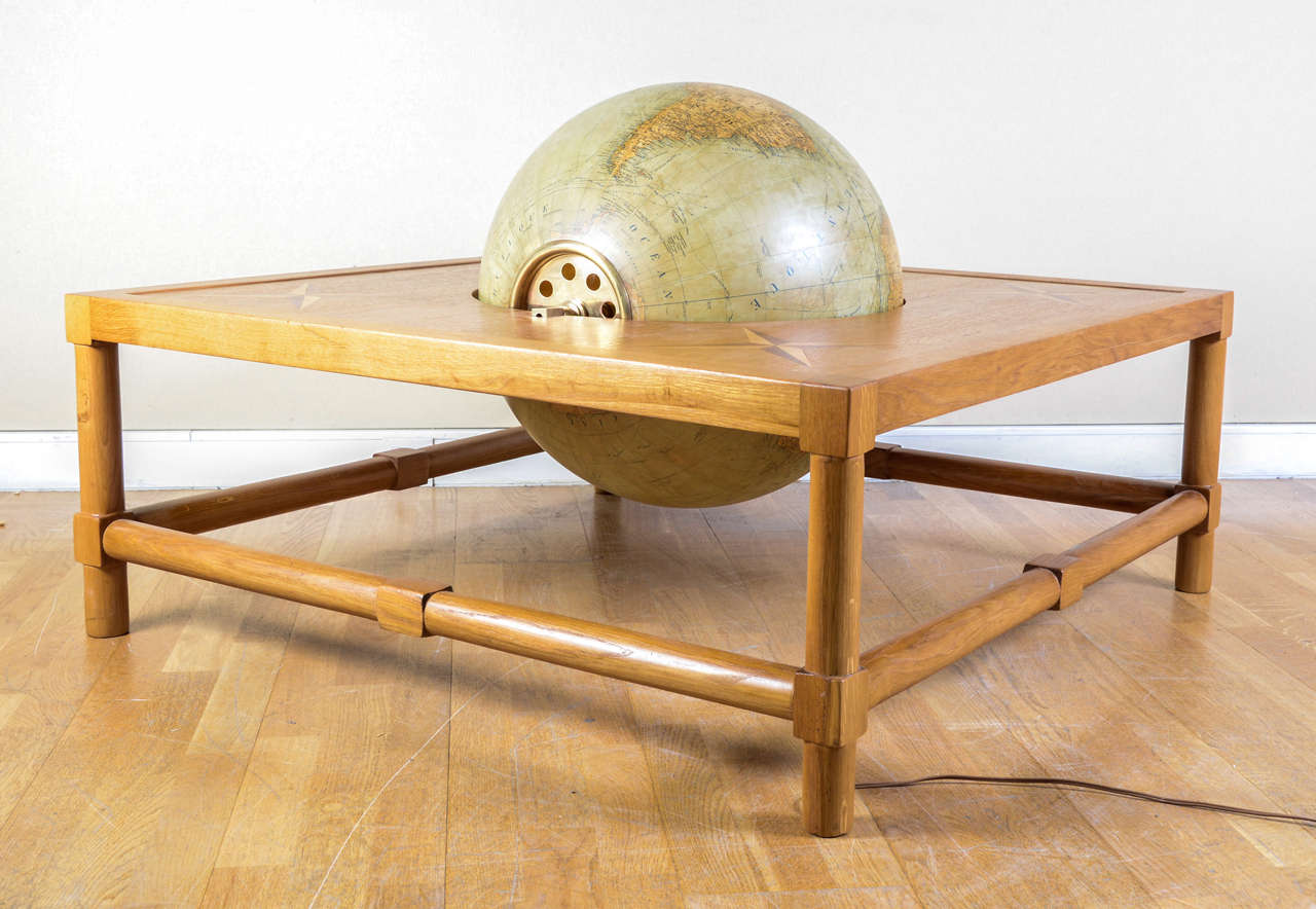 Rare and beautiful coffee table circa 1948 by Jacques Adnet in light oak. Legs are typical of the artist creations, the top is in marquetry of cornerstone stars with a lighted glass globe. Cartography was made by Girard, Barrère and Thomas.
