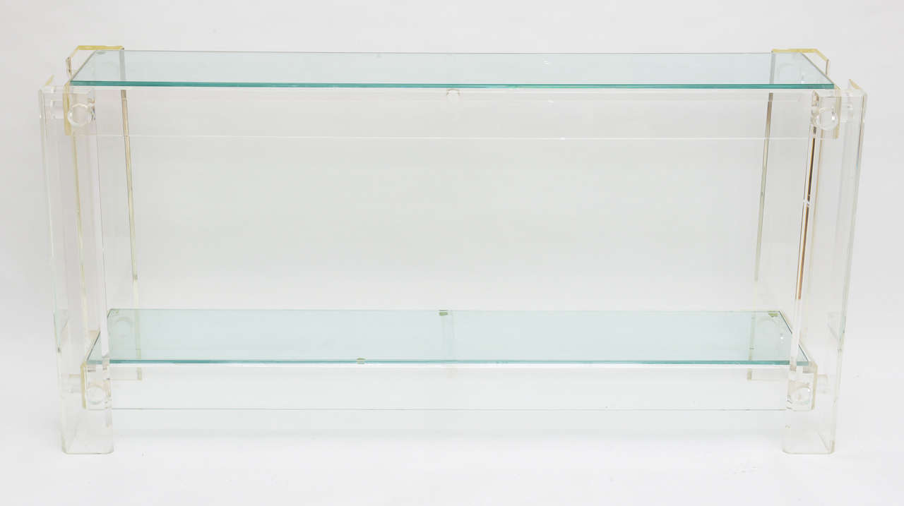 Lucite console with glass shelves.