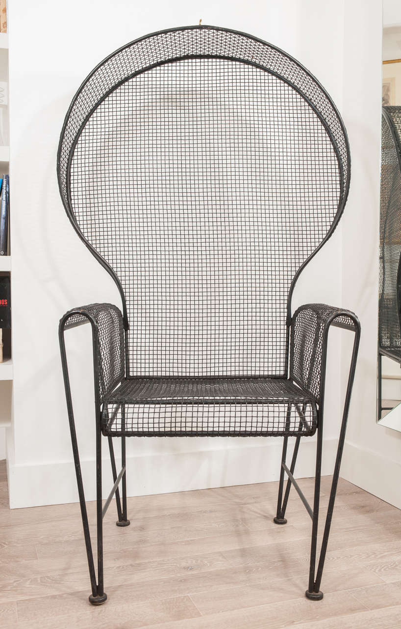 A very unique and playful mid-century black iron throne chair. Tight woven black metal detailing throughout the entire piece gives it a light and airy look.