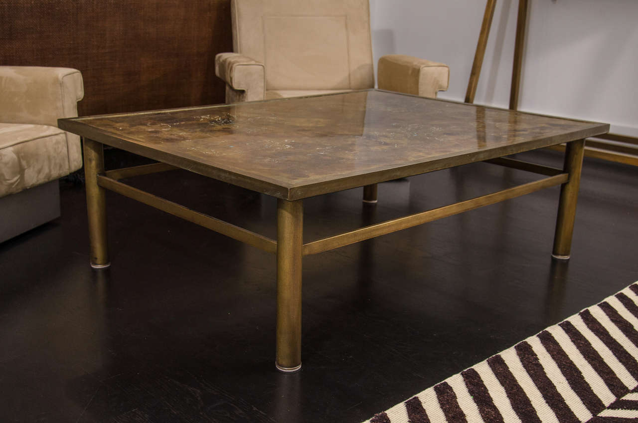 Bronze table by P&K Laverne, etched with zodiac figures on oxidized bronze top.  Stands on bronze tubular legs.