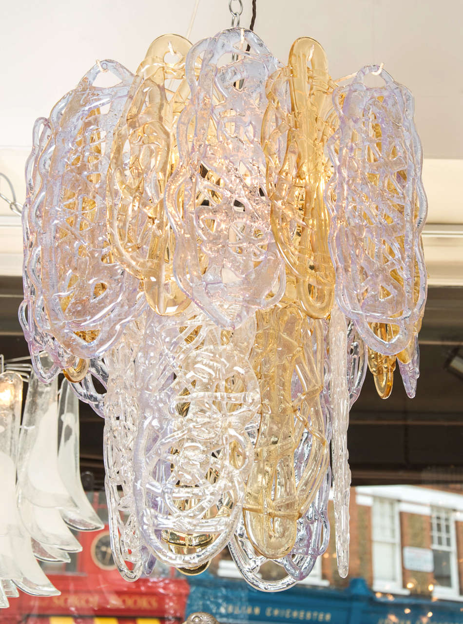 Beautiful two-tiered chandelier comprising 24 individual large glass pieces formed to look like spun sugar in delicate tones of pale lilac and amber.
