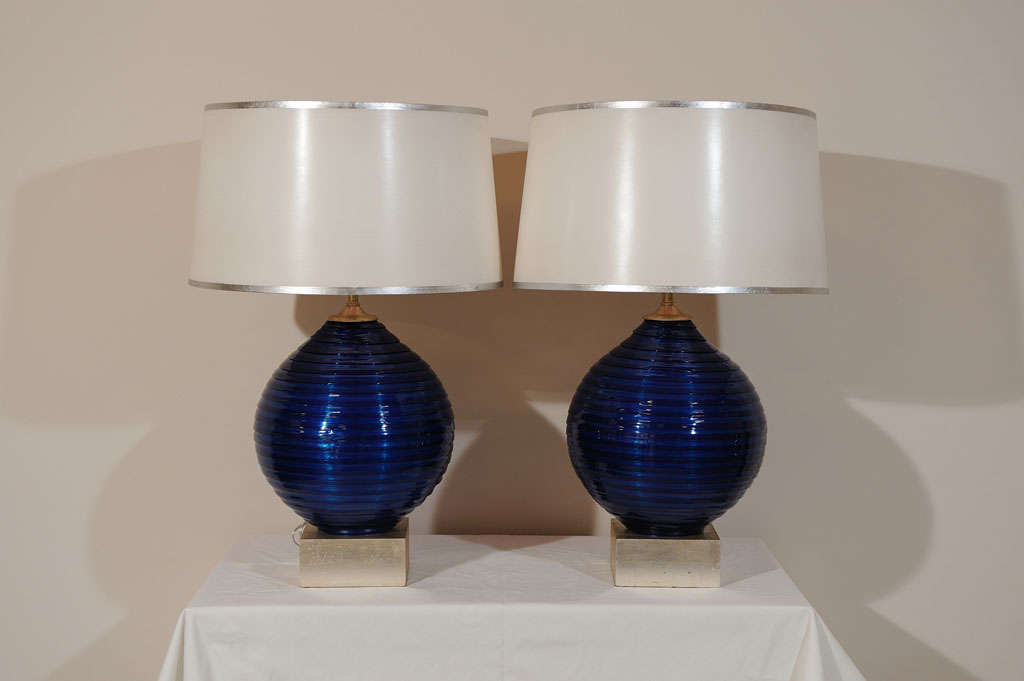 Pair of spun acrylic ball shape table lamps with silver leaf wooden block base. Possibly made by Rougier. Custom card shade with silver leaf border. Rewired.