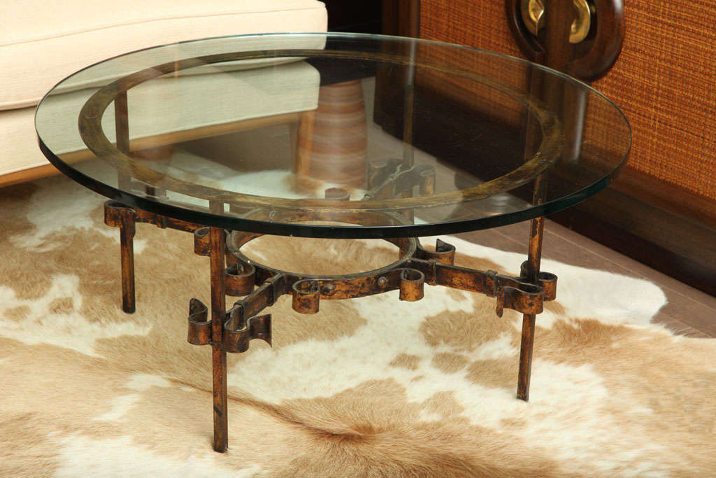 Round glass cocktail table with decorative gold painted iron base, Italian c. 1950