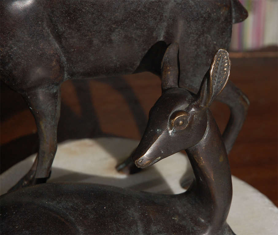 bronze sculpture depicting deer and fawn on stone slab