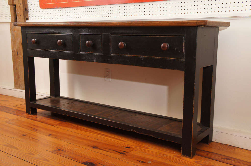 Very functional with simple lines describes this 1870 English pot board server is black paint. The top and pot board are not painted which is a great contrast to the worn black paint. it has two large drawers and small center drawer. the potboard is