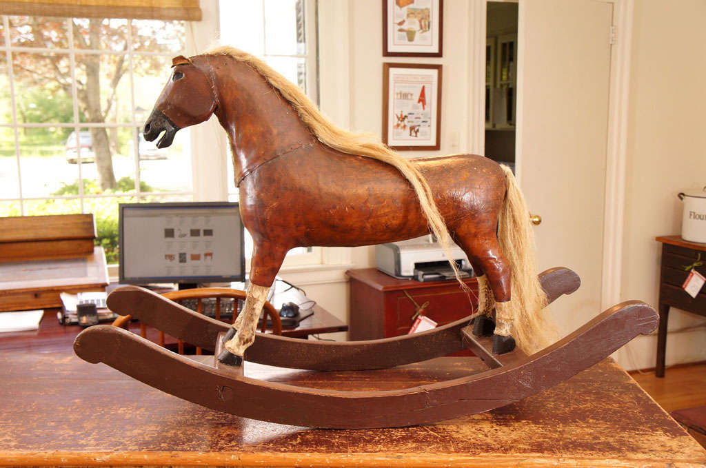 Our child size French rocking horse is made of nicely aged leather and has real fur legs. It also has real horse hair tail and mane. Hi is in great condition.