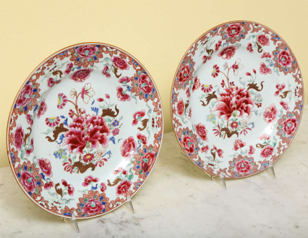 Fine set of 12 antique Chinese export porcelain famille rose plates, decorated with a central peony with sprays of foliage and flowers in pinks,red, yellow, blue and green on an undulating cafe au lait border. Yongzheng period (1723-1735). The