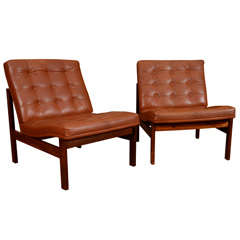 Pair of quilted leather lounge chairs, mfg. France and Sons