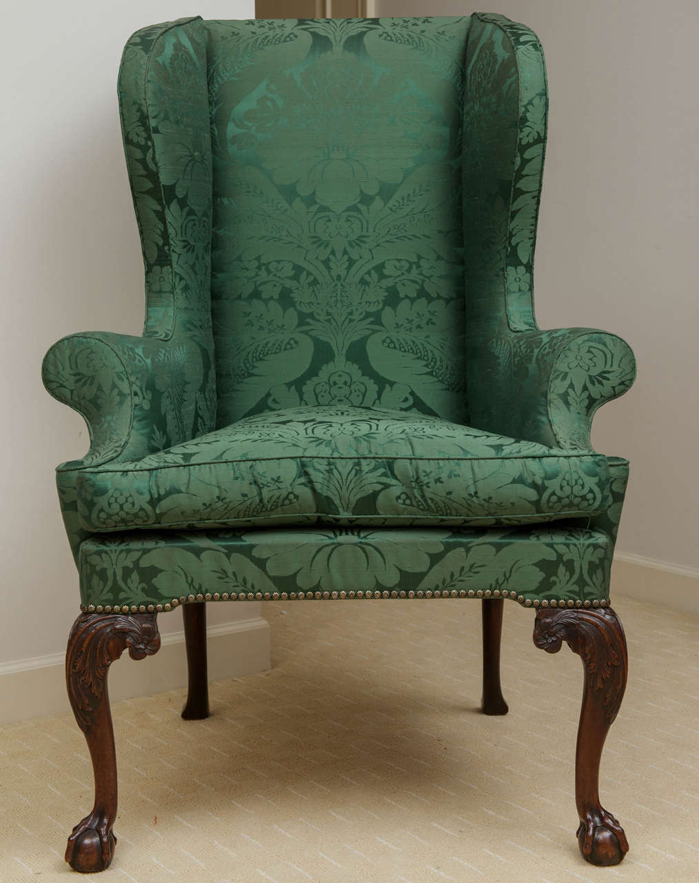 The frame over upholstered in green silk brocade and having scrolled arms and elegantly attenuated cabriole legs with acanthus leaf carved knees and terminating in ball and claw feet.
Provenance: Stair & Co., London, UK