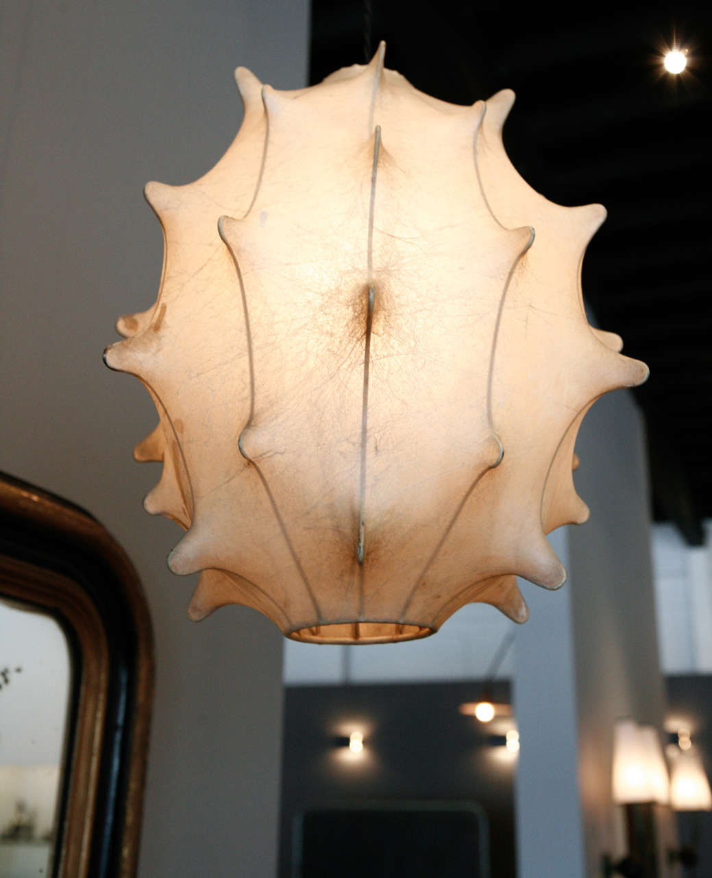 a ceiling pendant by achille castigioni produced in italy. this model was produced only for a short period of time and is no longer in production.