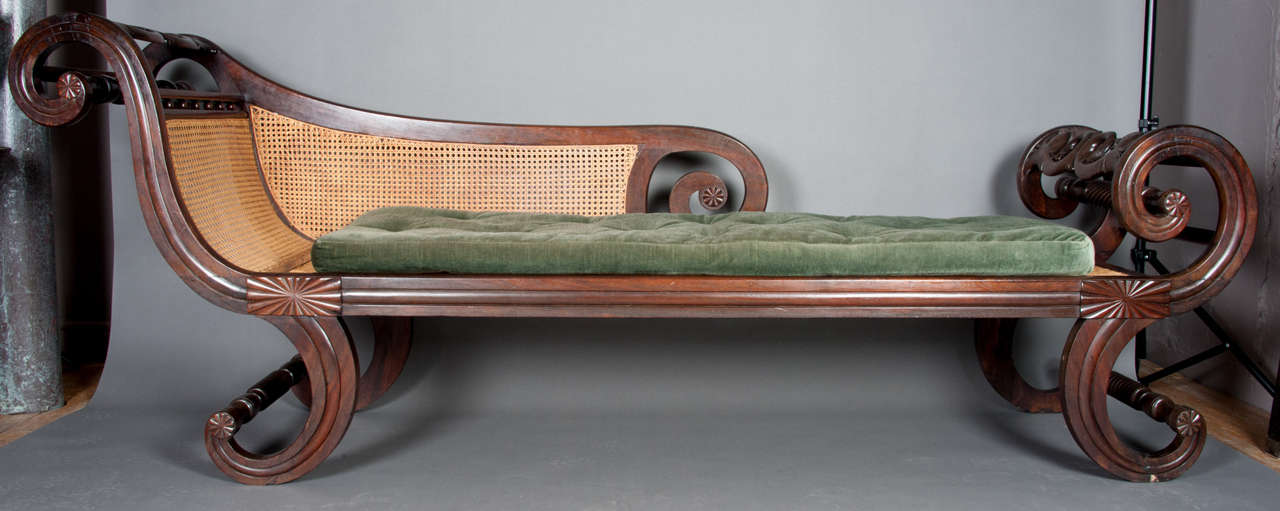 An early 19th century Anglo-Chinese chaise longue or daybed in the European style, made of Huanghuali, Chinese hardwood.
The scrolling terminals are carved to represent mythological spirits.

L:8’ (244cm) H: 3’ (91.5cm) D: 2’(61cm)