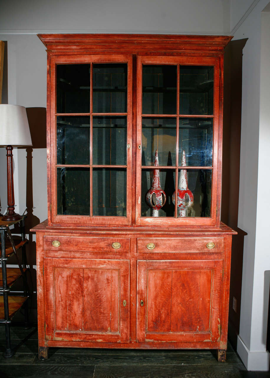 Late 19th century Belgian red painted bookcase with glazed doors and lower cabinet panel doors. Great use as a cabinet, cupboard, bookcase or wardrobe.
