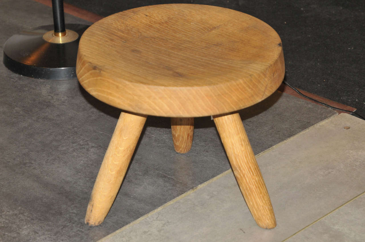 1955 oak stool by Charlotte Perriand, on three legs.