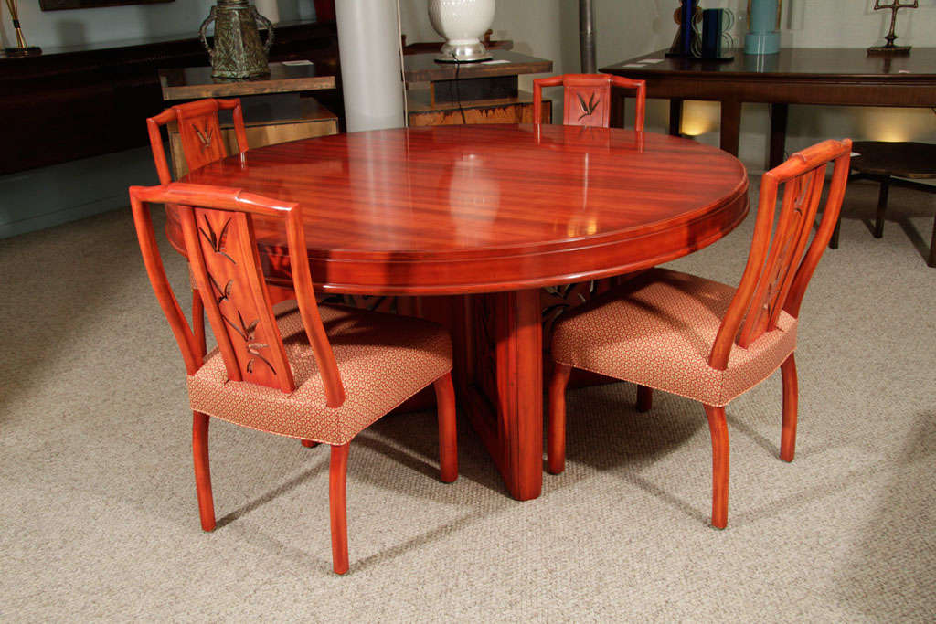 Flame-red, original custom lacquer finish. Cross base with Asian-inspired carvings. This table is a great example of Mont's unusual custom lacquer finishes. Measures: 2 x 12" extensions. Table fully opens to 86 1/2".