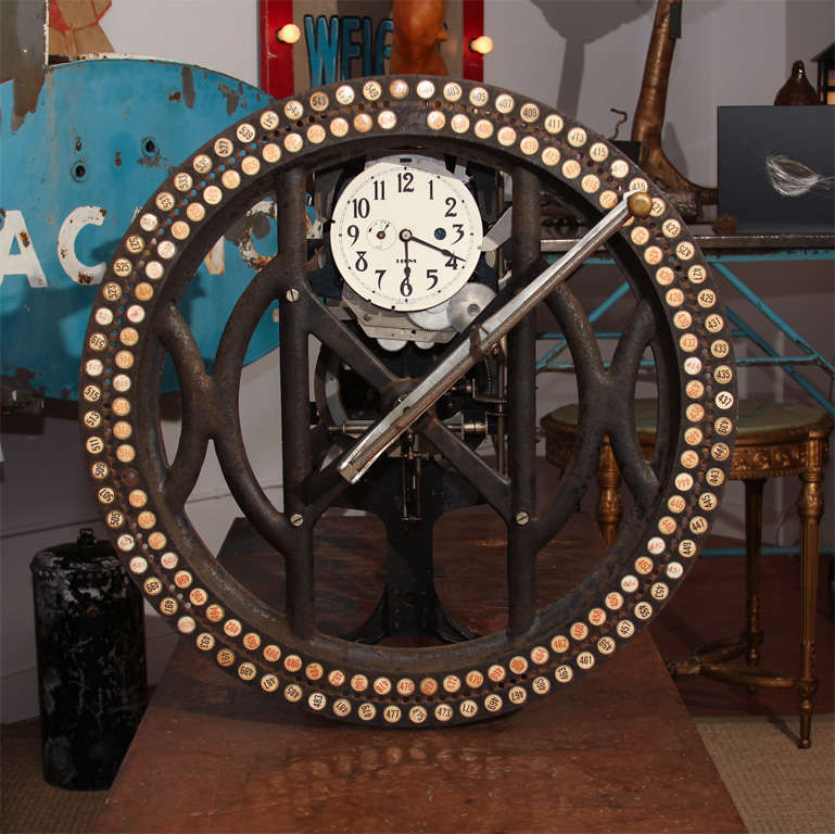 Spectacular, old signed IBM time clock with a cast-iron facade with employee numbers and a moving, hand-held device for logging each punch-in and punch-out.  A date and time stamp is made on the papered cylinder in back. Highly sculptural with