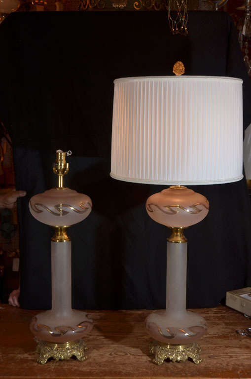 Pair, 1950's, Hollywood Regency Style, delicate pink, satin glass table lamps with swirling gold design, top and bottom, made to look like oil lamps but have always been electric.  Priced without lamp shades.  Shown with retro style, pleated silk