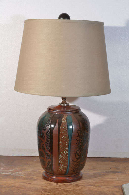 Hand Made, Multicolored Pottery Jar turned on a lathe, as a Table Lamp, mounted on hand made wooden base with a wooden top. Lamp is newly electrified with 3 way socket.  Priced without the lamp shade.  Shown with taupe 14
