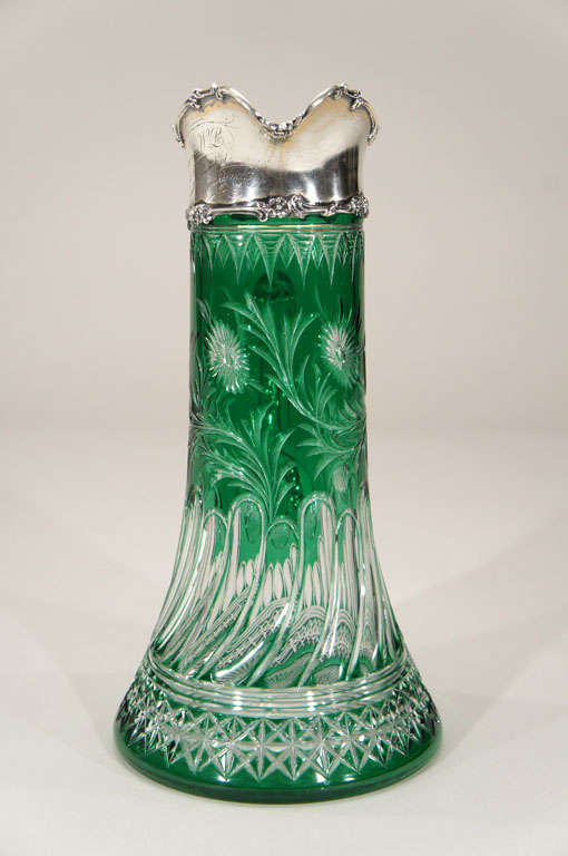 This handblown crystal ewer or pitcher is a fabulous example of Stevens and Williams extraordinary workmanship. The apple green overlay is cut to clear in a swirling Art Nouveau pattern and copper wheel engraved floral decoration. Clearly a